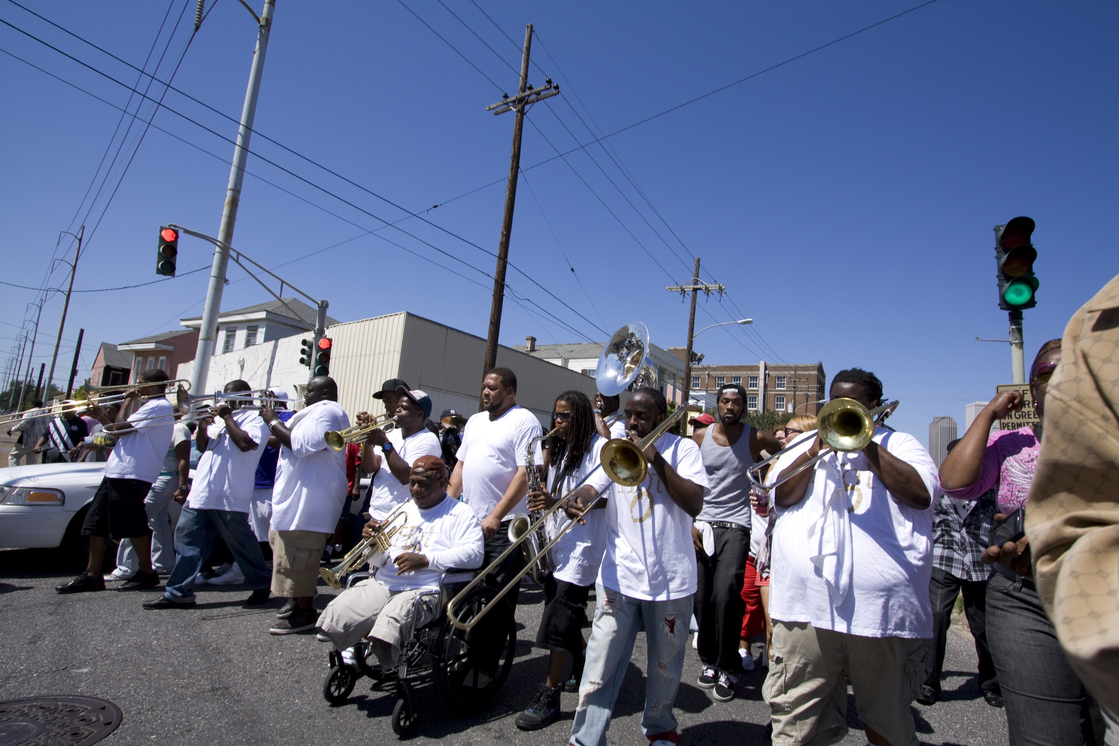 Hot 8 Brass Band musicians playing in a New Orleans street during the Single Ladies second-line parade