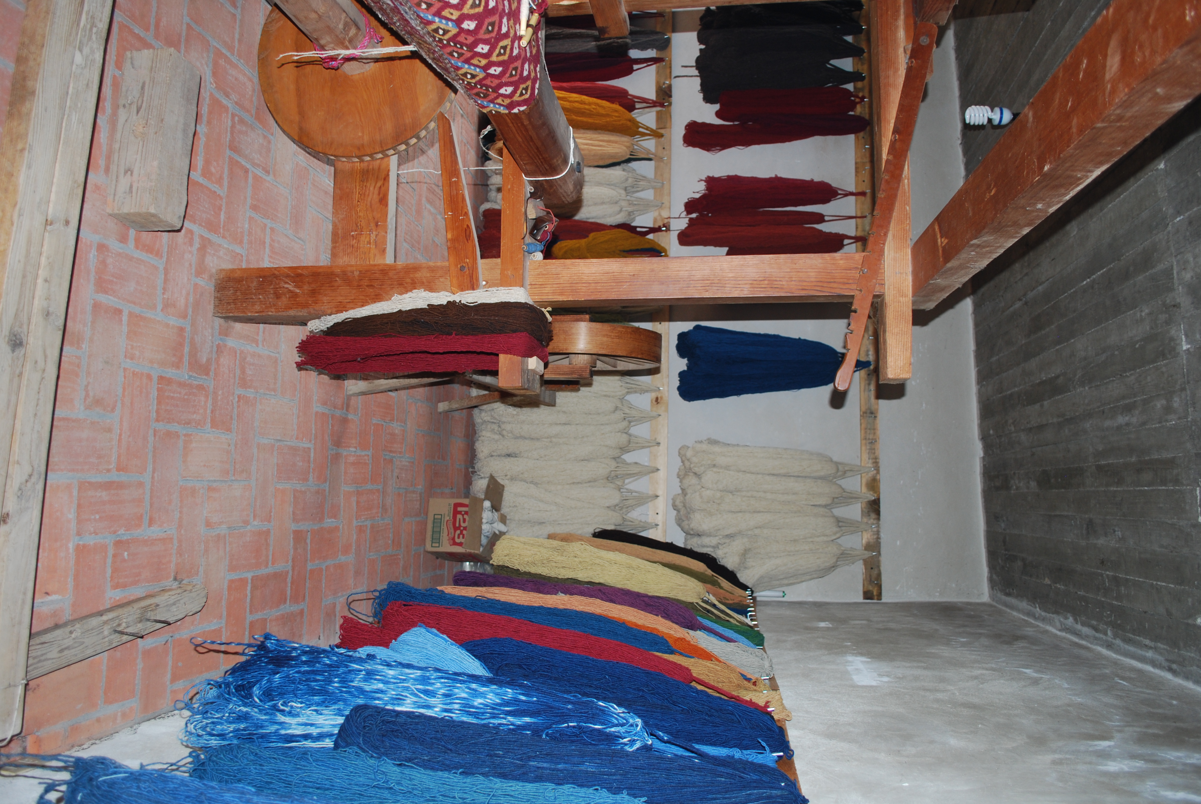 Wooden loom and skeins of colored wool in the Porfirio Gutierrez family workshop in Teotitlán del Valle