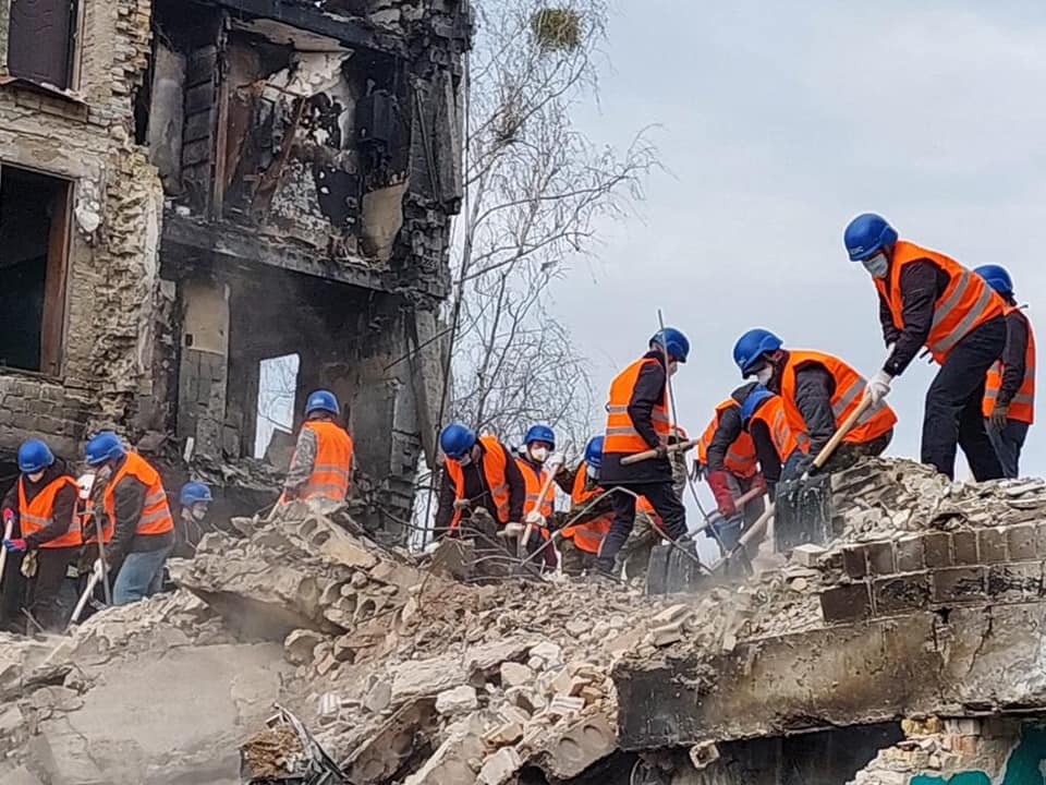 A team clears rubble in Borodianka, Kyiv region, on April 8, 2022, during an emergency operation involving rescuers and volunteers.
